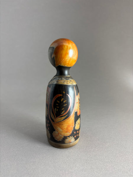 Kokeshi kimono foncé, tête orange petites mèches.
